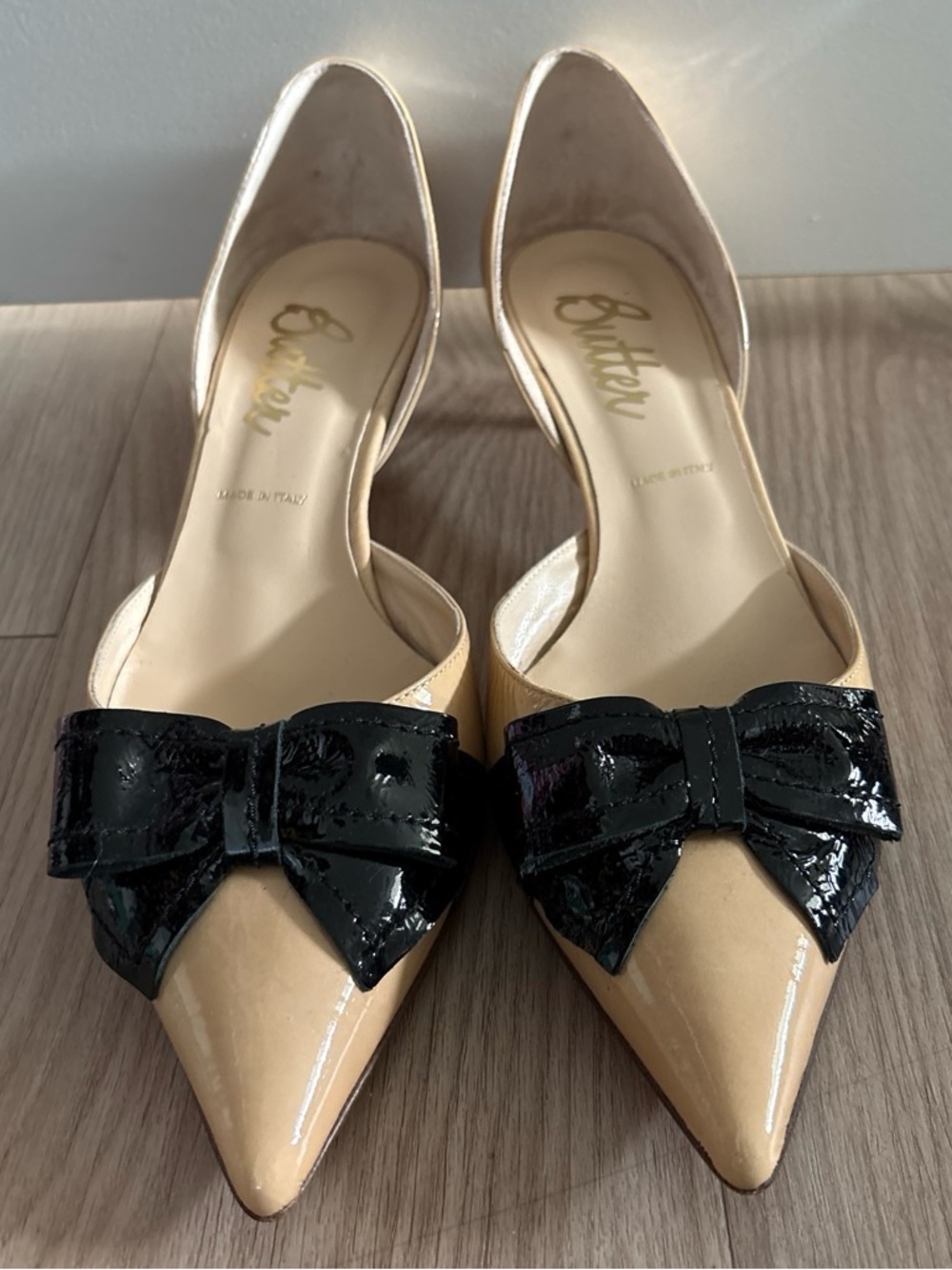 Butter Beige Pointed-Toe D'Orsay Heels with Black Patent Bow